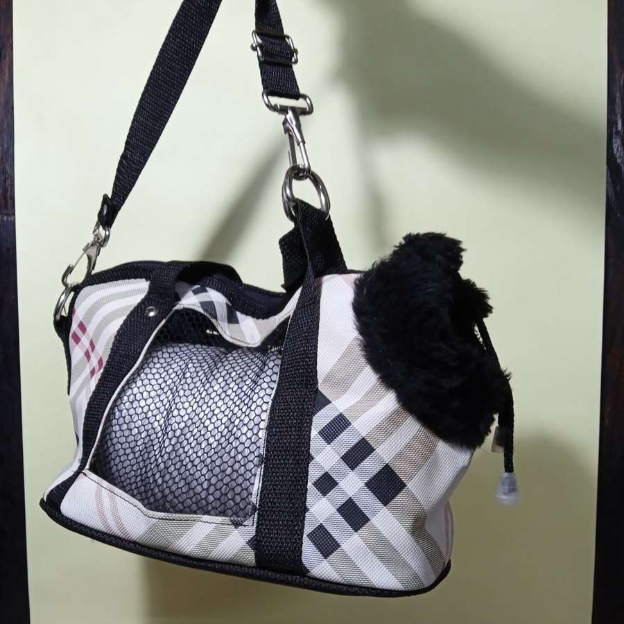 A soft carrier bag for a small dog - the 8 kg total weight limit includes the bag itself