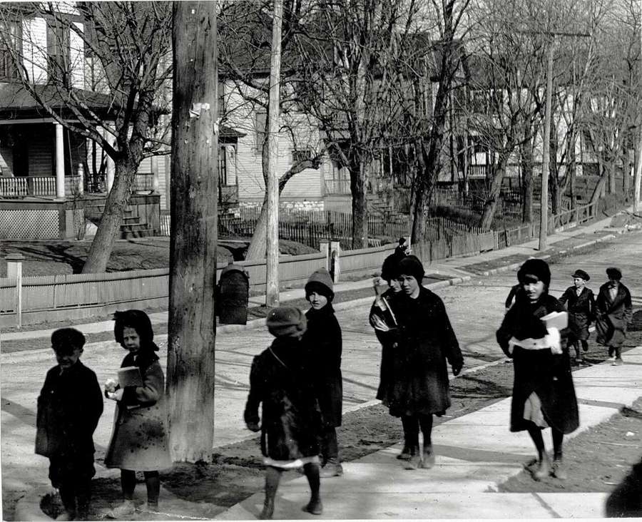 Children in winter coats walking to school
