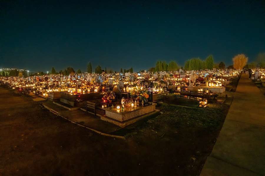 A Polish cemetery at night on All Saints’ Day, glowing with thousands of grave lanterns