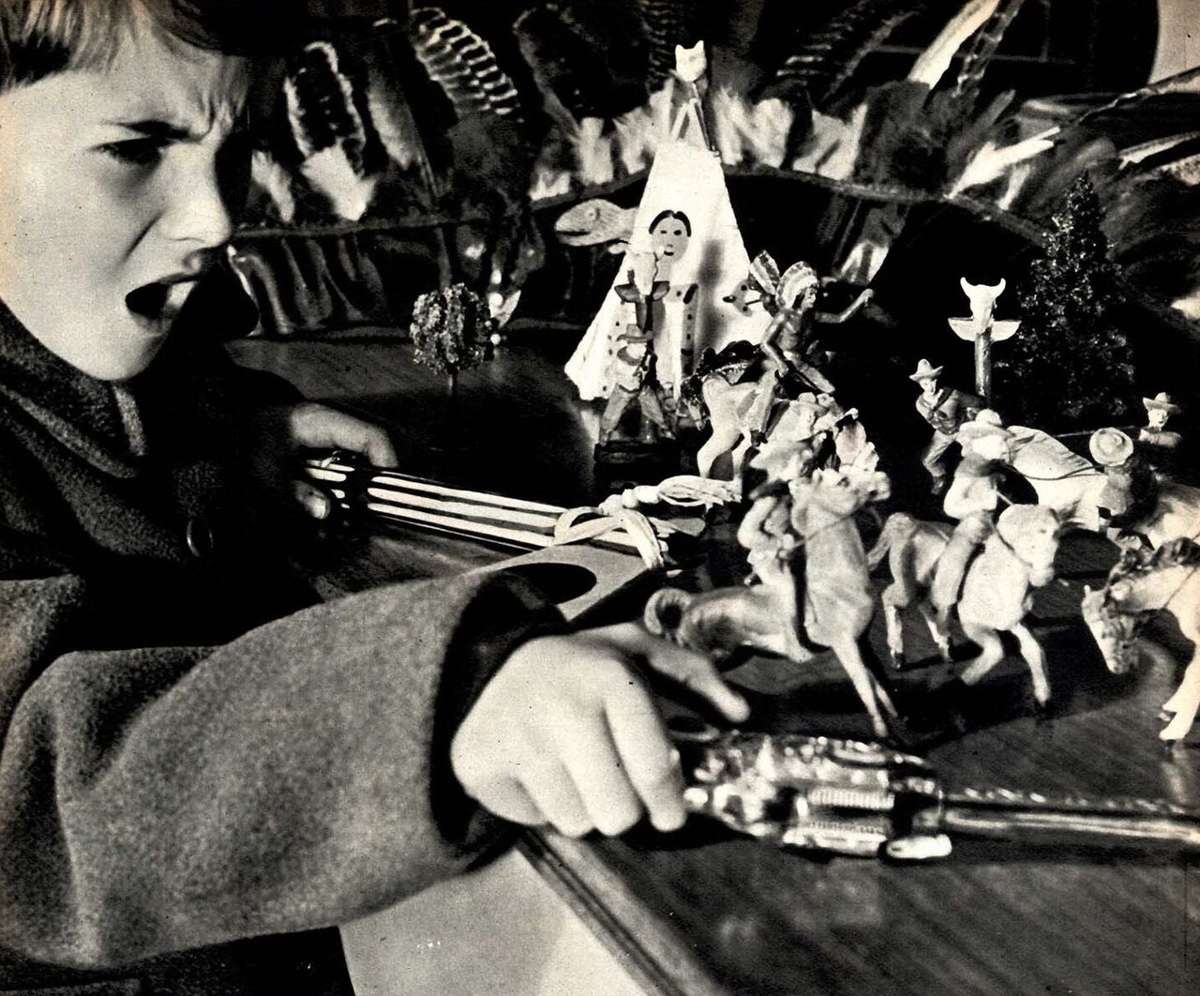 A child playing with toy soldiers in 1951, illustrative