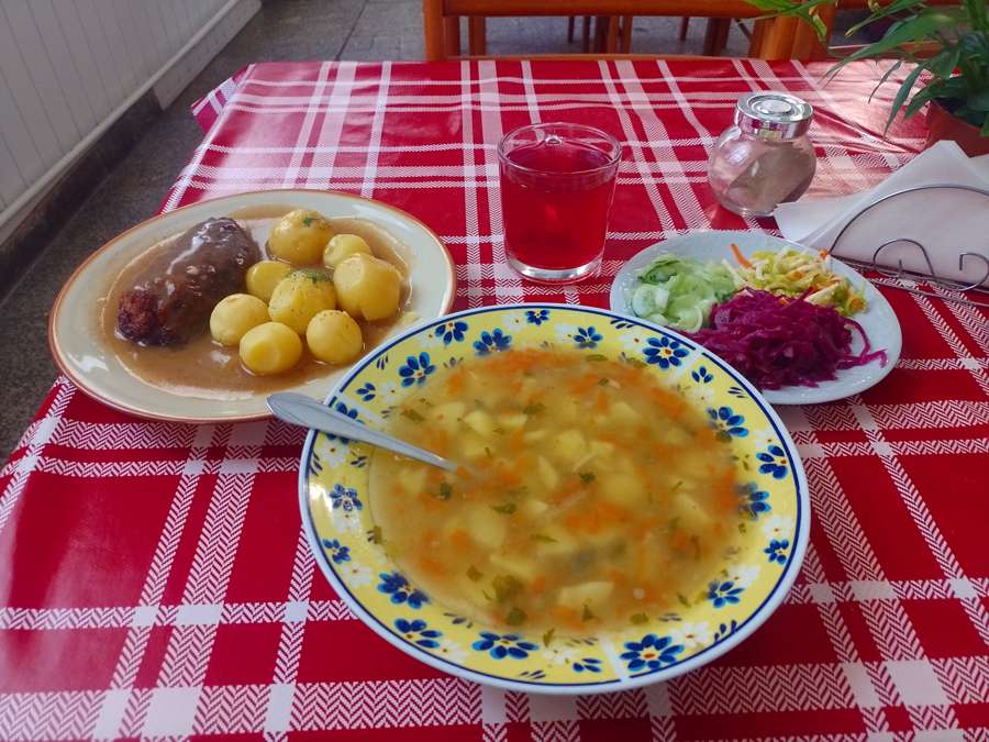 A milk bar lunch set of soup, meat with potatoes, salads and kompot at Bar Mleczny Kolorowa in Nowa Ruda