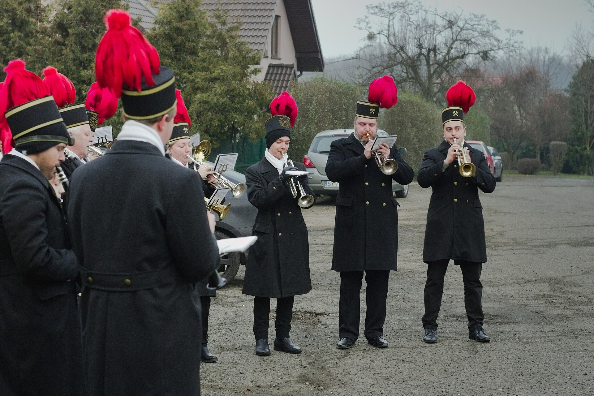 Miners' orchestra in black gala uniforms and red-plumed czako hats plays the traditional dawn wake-up call in Bytom-Miechowice