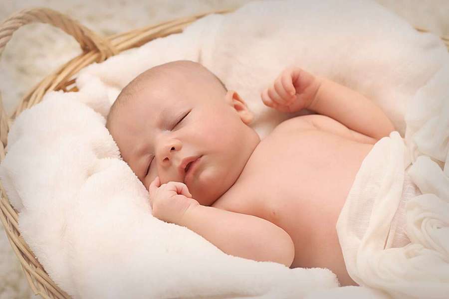 Newborn baby sleeping in a basket