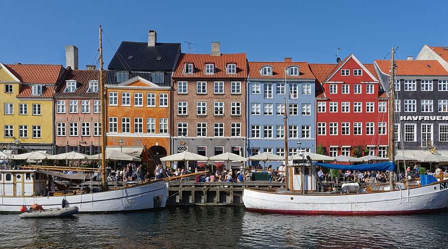 Colourful historic houses and boats along the Nyhavn canal in Copenhagen