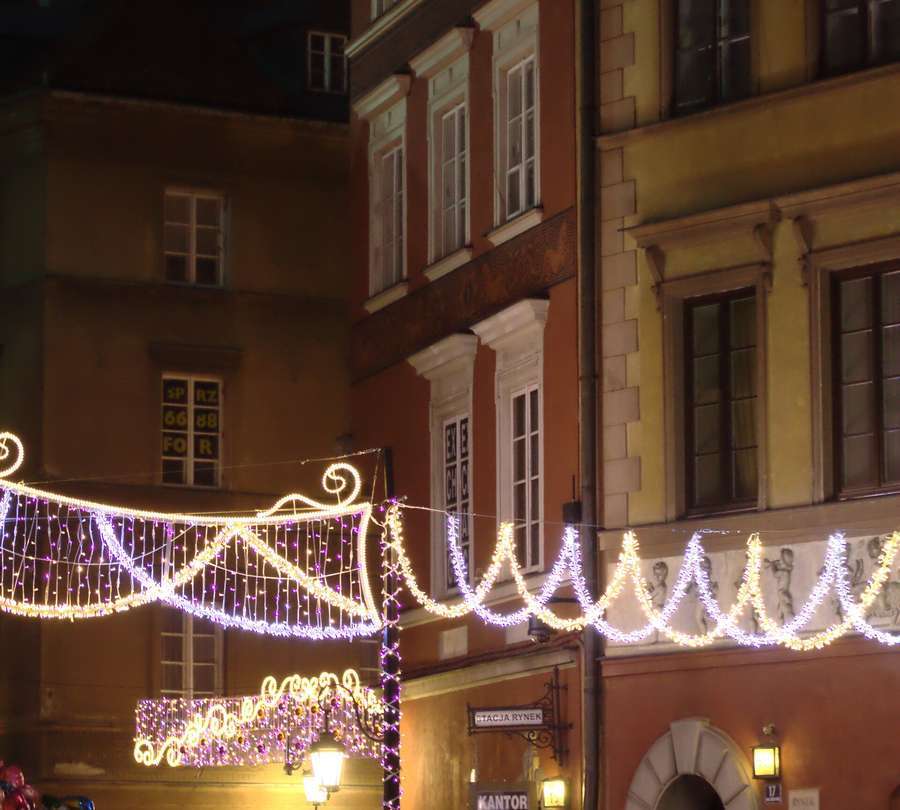 Christmas light garlands above Warsaw's Old Town Market Square at night