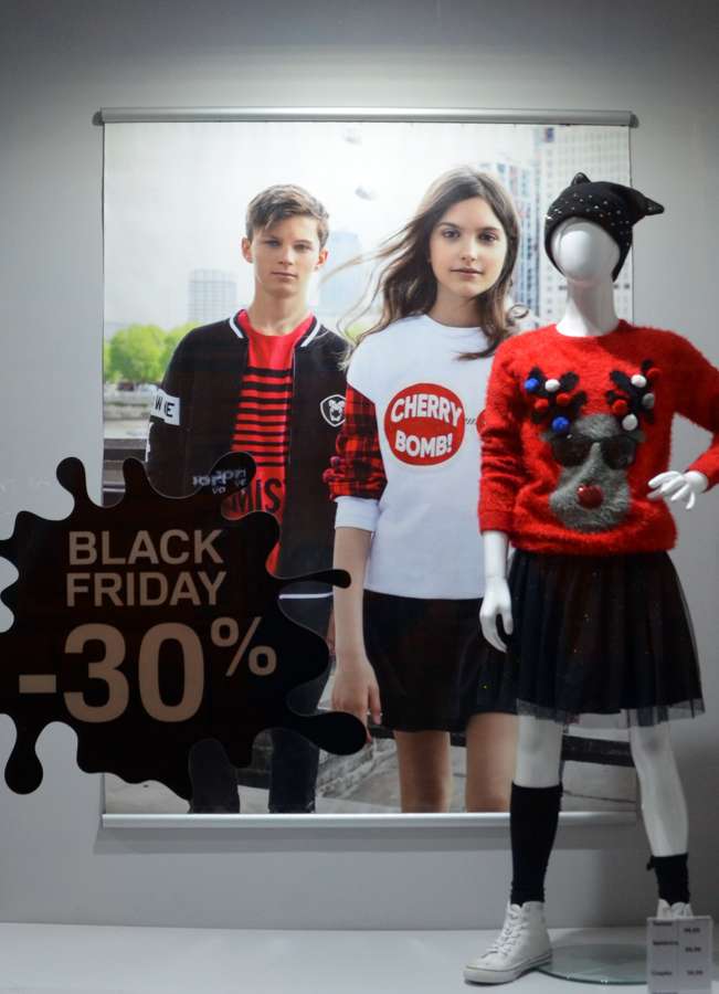 A Black Friday minus 30 percent sign on a clothing shop window in Sanok, Poland