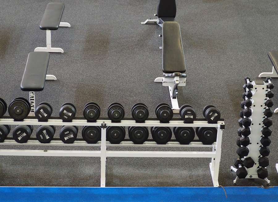 Dumbbell racks and benches in an empty gym