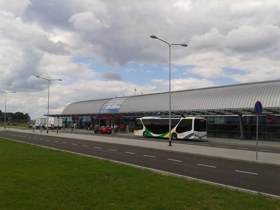 Warsaw Modlin Airport terminal exterior with the airport shuttle bus