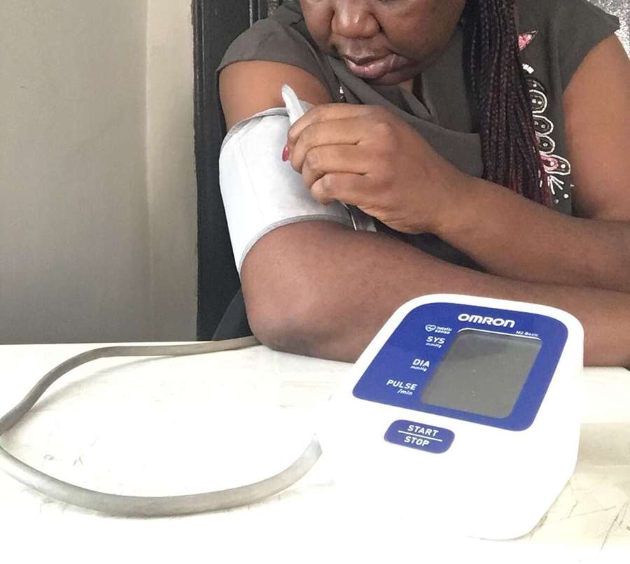 Person checking blood pressure at home