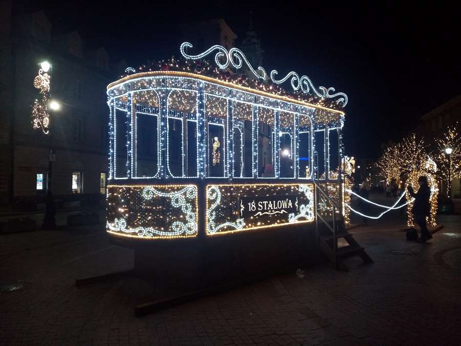 Christmas tram-shaped light installation on Krakowskie Przedmieście in Warsaw at night