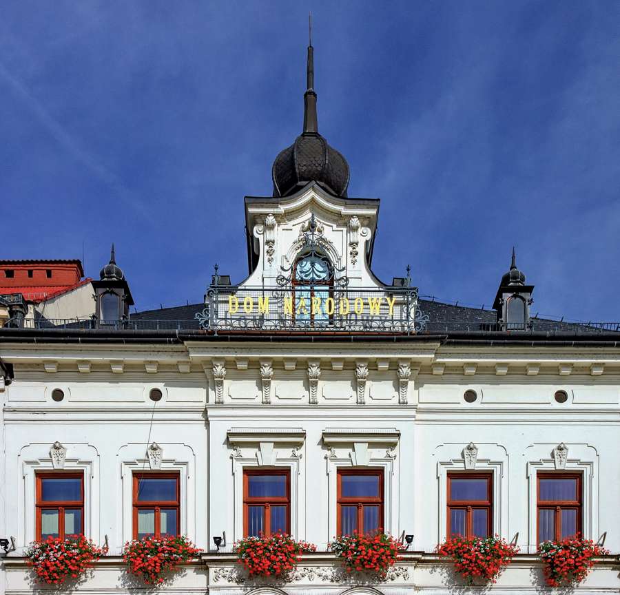 The facade of the National House on the market square in Cieszyn with flower boxes