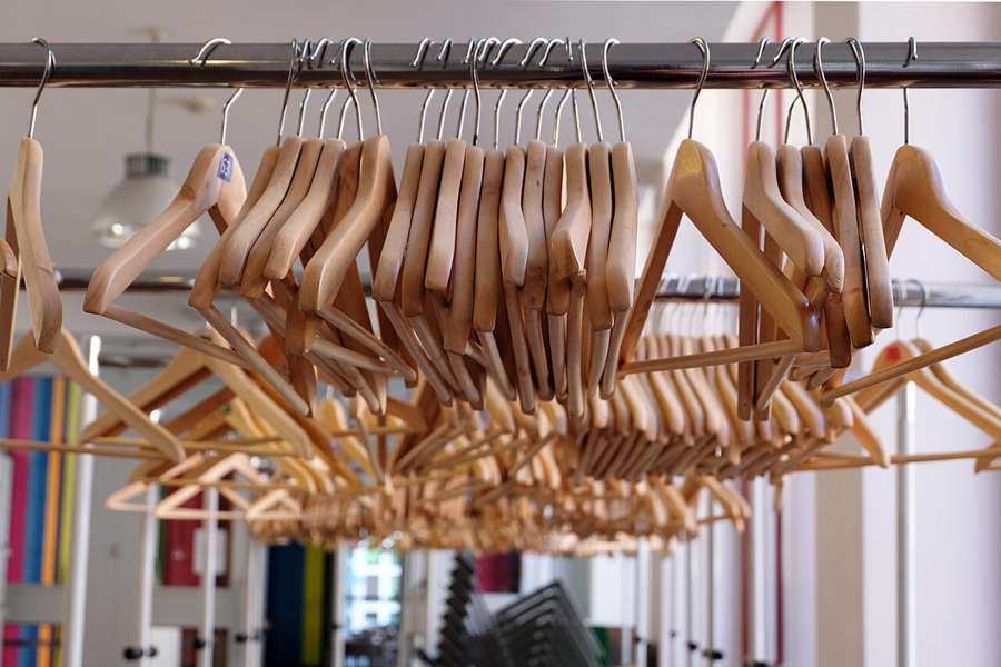 Wooden clothes hangers on a rail, an illustrative photograph by Christian Fregnan