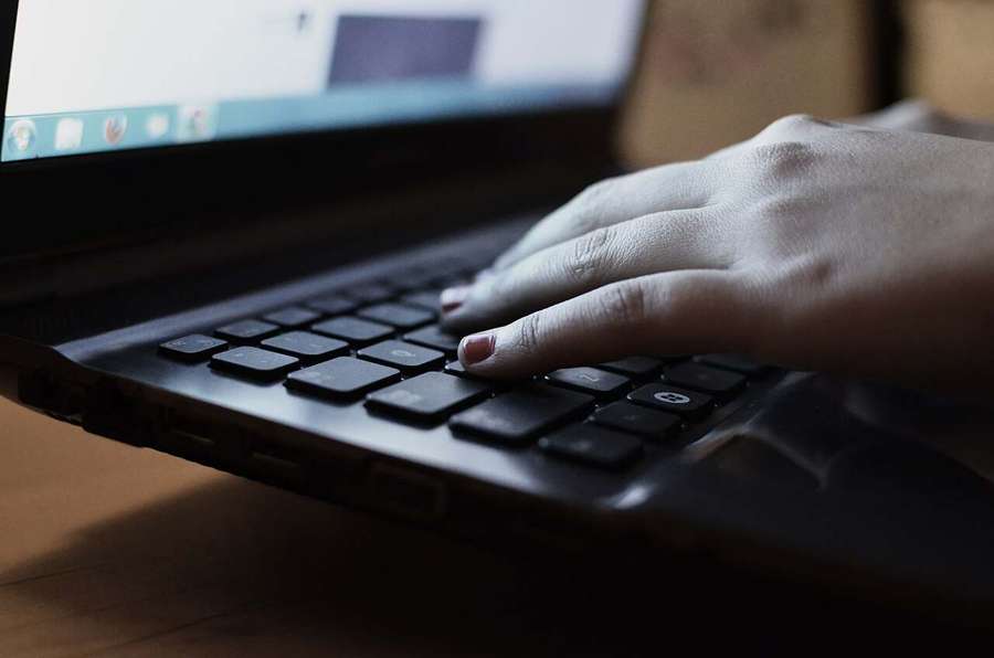 Typing on a laptop