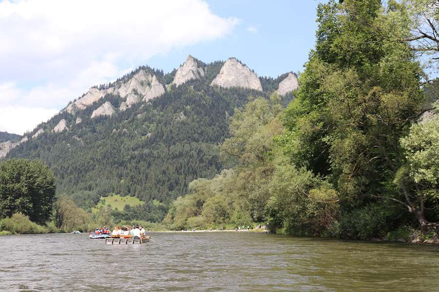 Trzy Korony peaks above the Dunajec river with a small raft