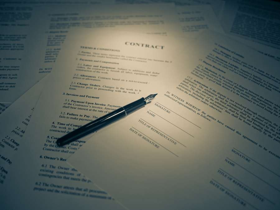 A fountain pen resting on contract documents ready for signature