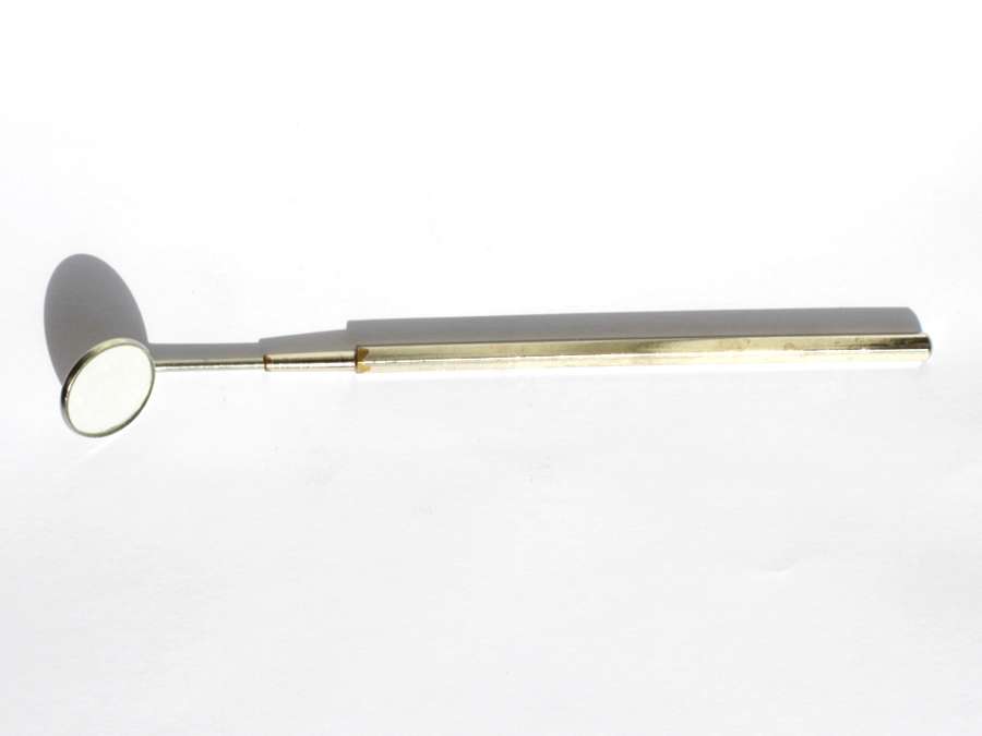 A dental mouth mirror on a white background