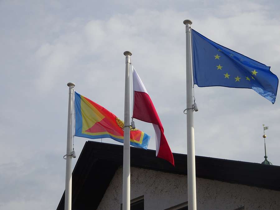 Flags flying on Frombork's market square, Poland