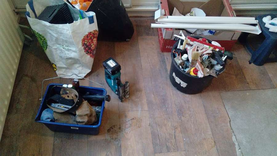 A tradesperson's tools and materials on the floor of a flat mid-renovation