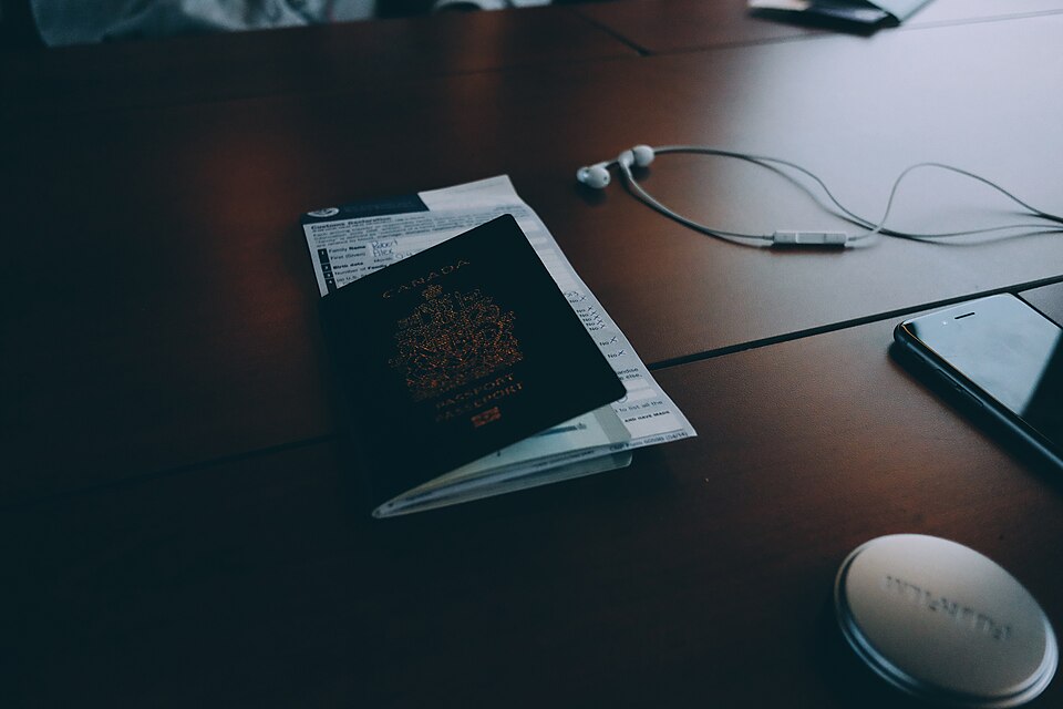 A passport and travel documents on a desk - the first month in Poland is a paperwork month, and it ends