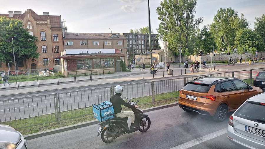 Wolt courier on a scooter on a Warsaw street