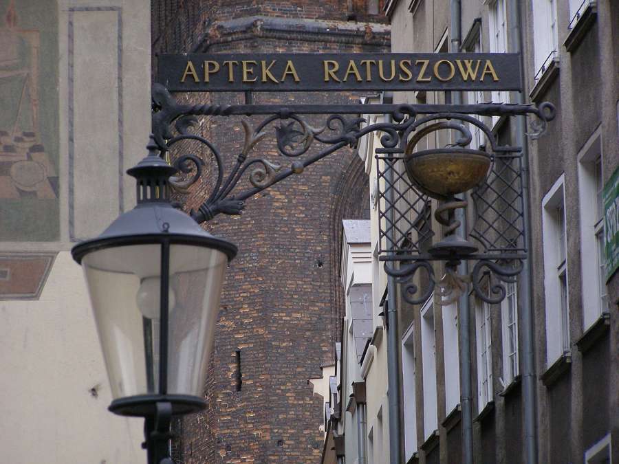 A traditional wrought-iron apteka sign in Gdańsk