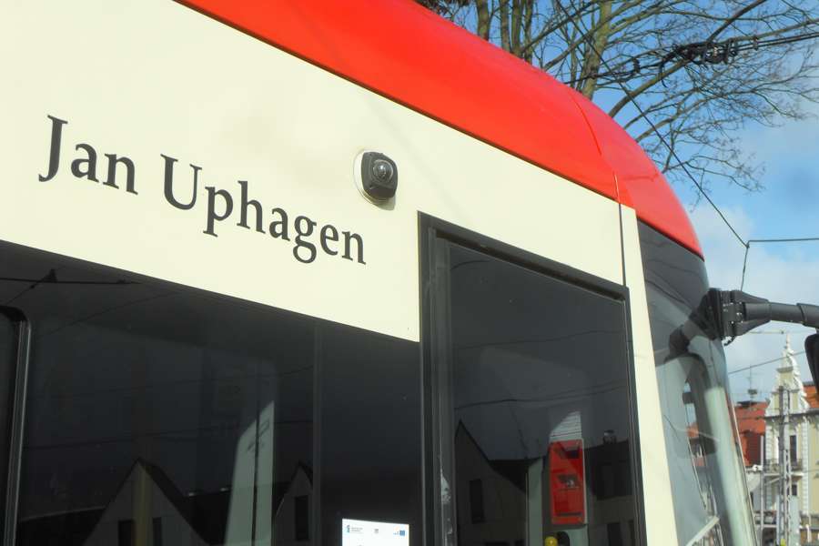 A red PESA Swing tram on a street in Gdańsk