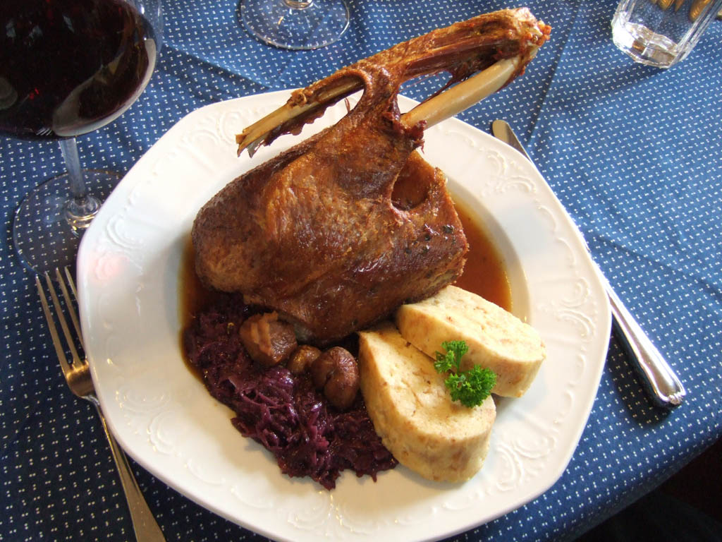 Roast St Martin's Day goose with red cabbage and bread dumplings, served with red wine