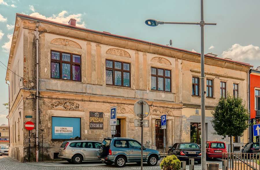 Historic building on the market square in Gorlice with parked cars in front