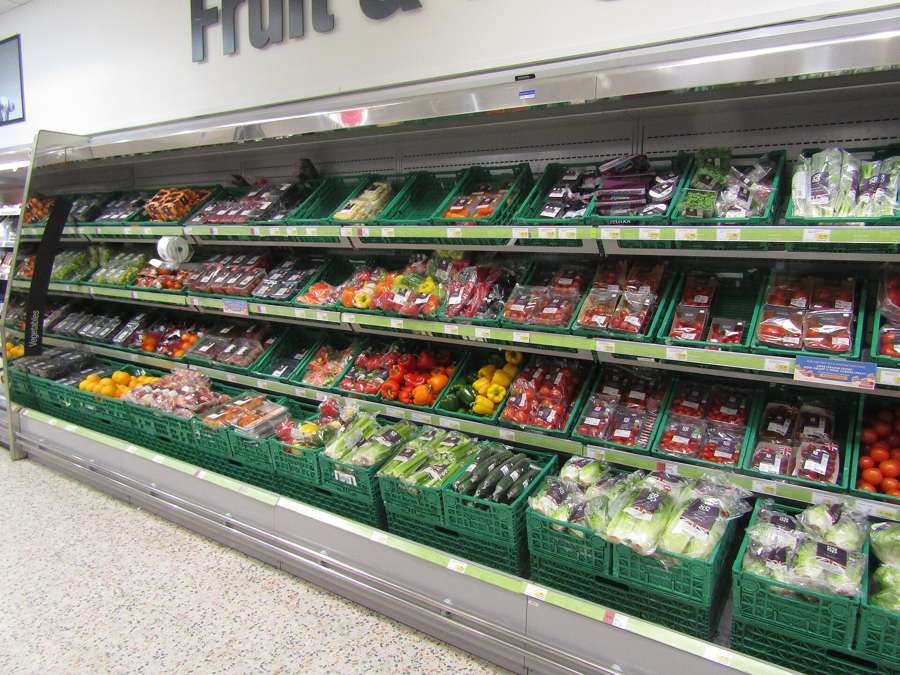 A supermarket fresh produce aisle - online supermarkets like Frisco deliver the full weekly shop, while apps cover the top-ups