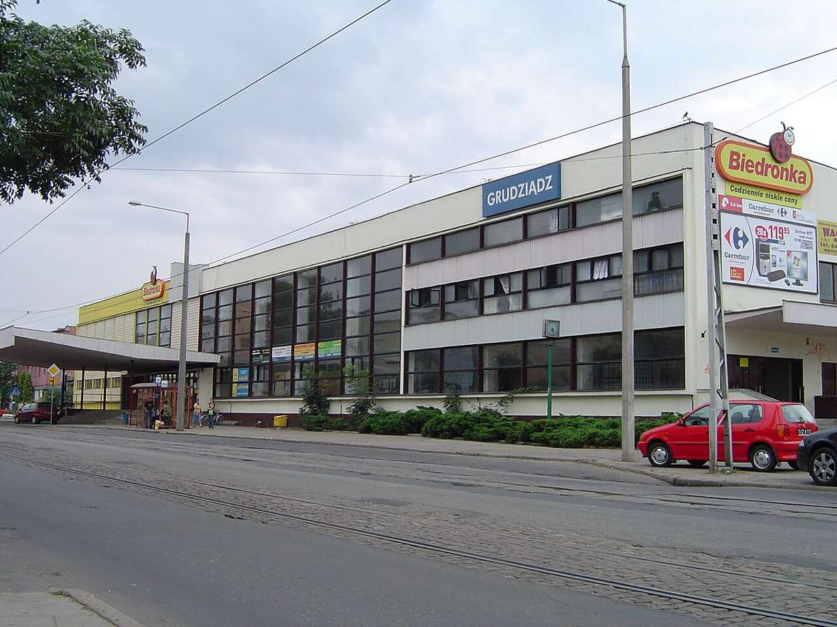 Grudziądz railway station building with tram tracks in front