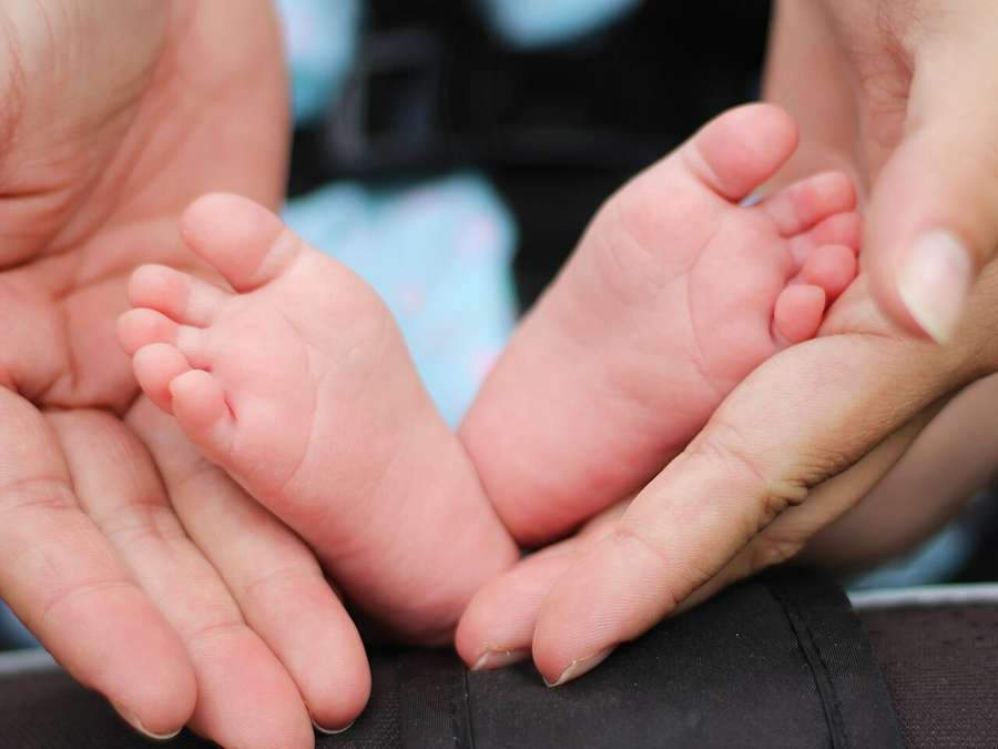 A sleeping newborn baby's tiny feet