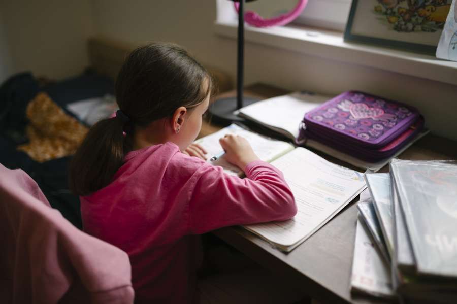 A girl studying at her desk at home - Polish law allows home education with a school director permit and annual exams