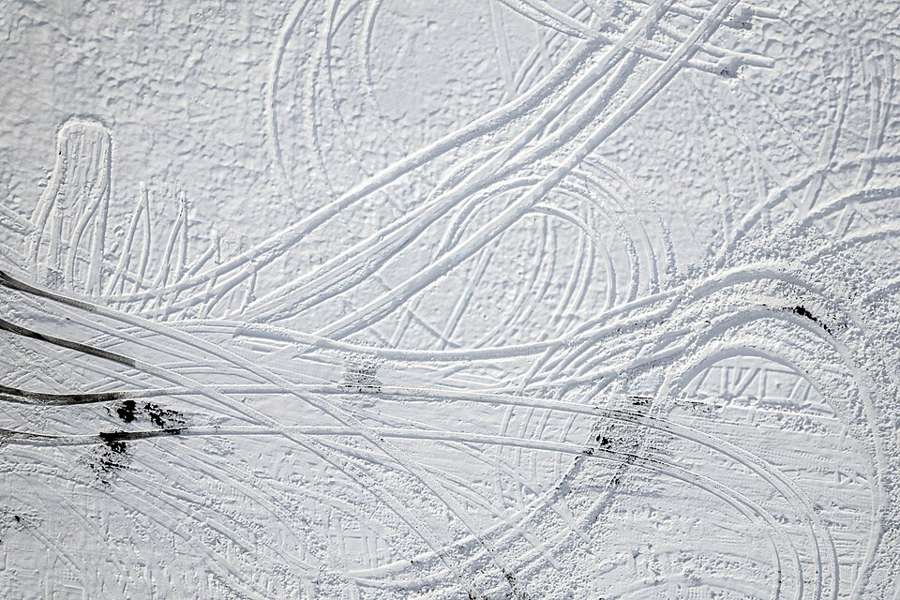 Tire tracks crossing fresh snow