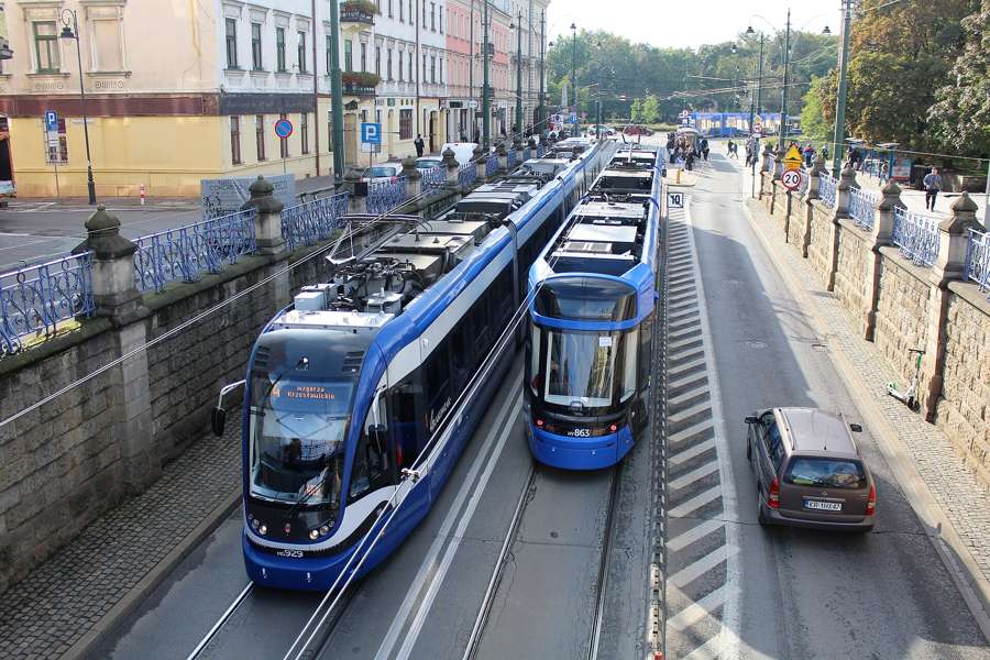 Two Krakow trams passing on a bridge over the railway cutting in the city centre, 2022