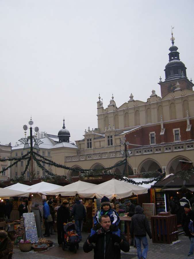 Market stalls beside the Cloth Hall on Kraków's Main Square during the Christmas fair