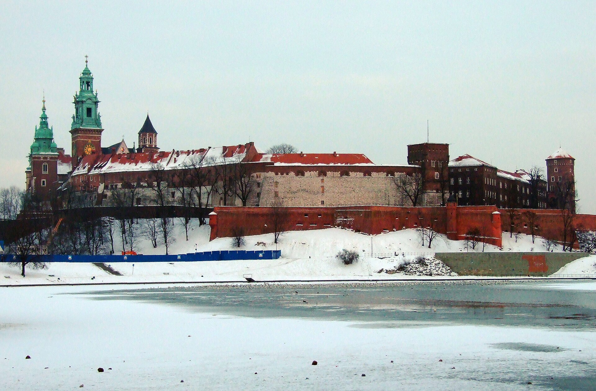 Wawel Royal Castle and Cathedral under snow, seen across the partly frozen Vistula river