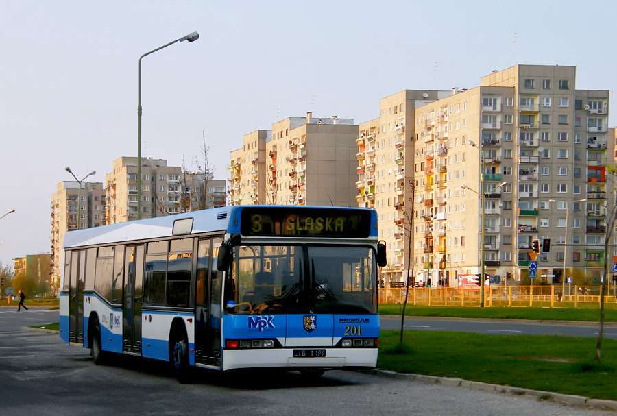 MPK Legnica bus on line 8 at a stop next to apartment blocks