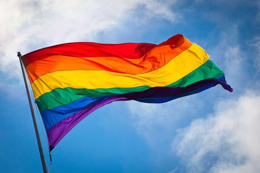 Rainbow flag against the sky - Poland's big cities have an organised LGBTQ+ scene despite no partnership law