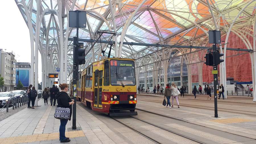 An MPK Lodz tram at the Lodz Centrum station under its colourful glass roof, July 2019