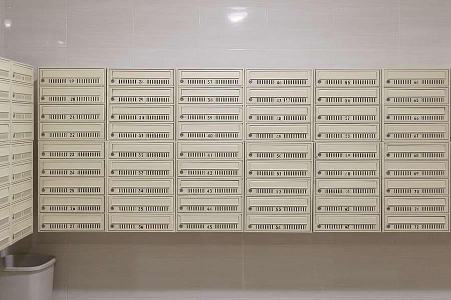 Wall-mounted letterboxes in a Warsaw apartment block, an illustrative photograph from 2020