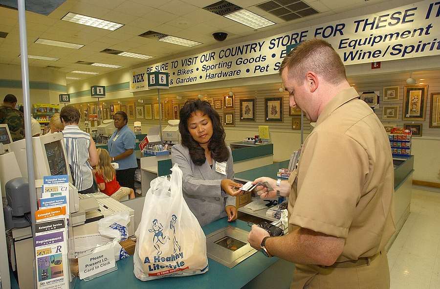 A shopper paying at a cashier counter