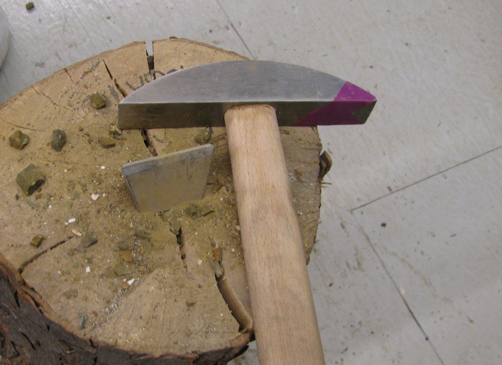 A mosaic hammer and hardie resting on a wooden block at a Pennsylvania workshop in May 2014