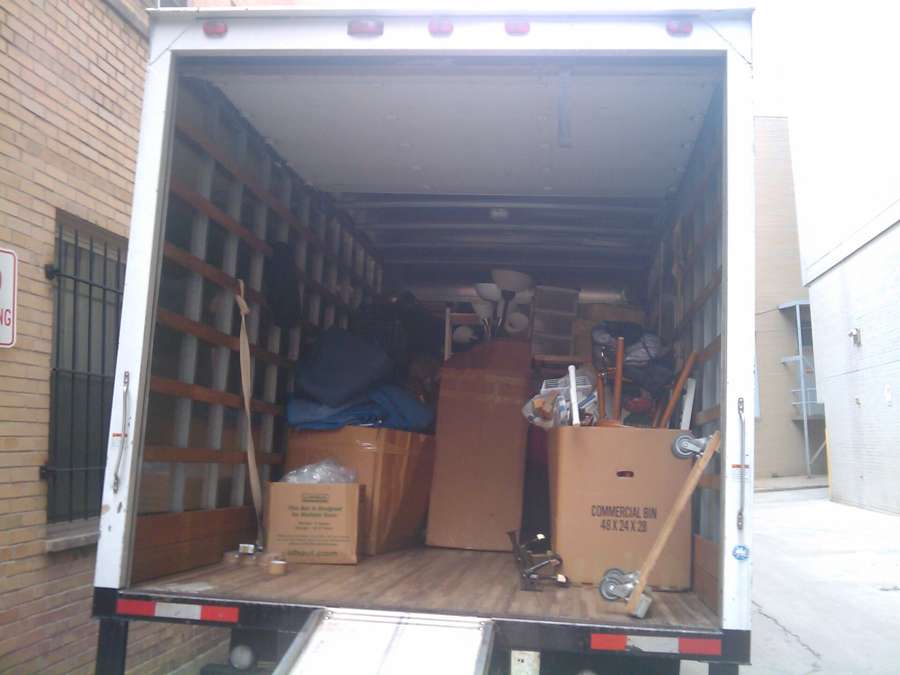 A removal truck loaded with furniture and moving boxes