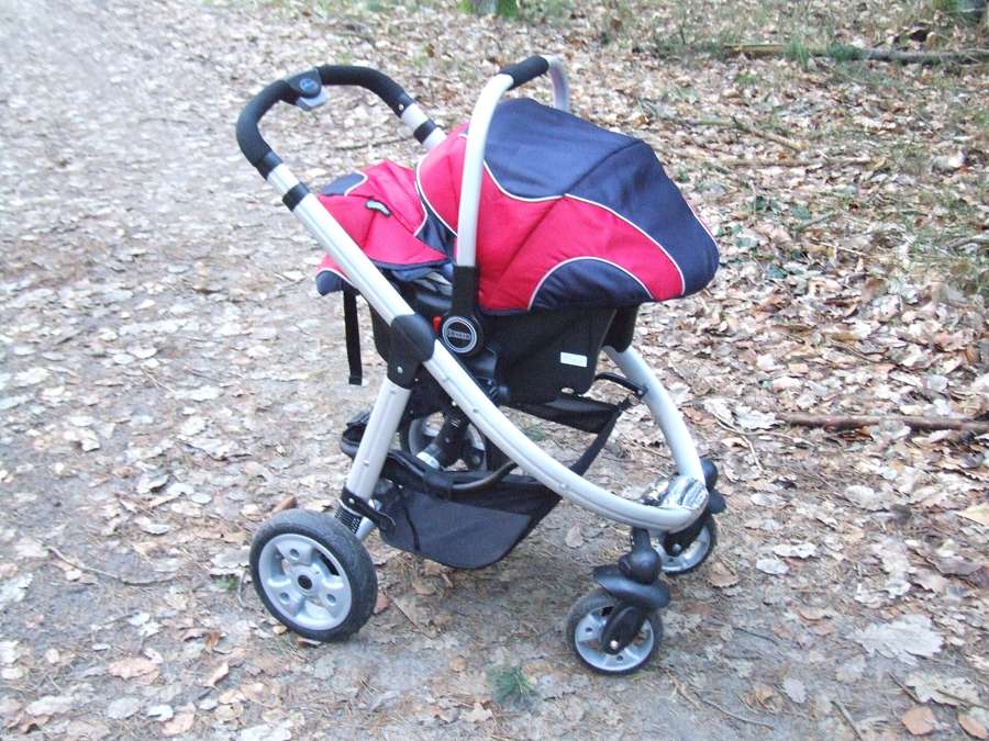 An empty baby stroller on a forest path