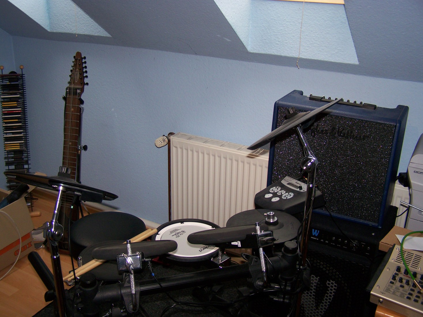 Electronic drums and amplifiers in a home music studio photographed in June 2009