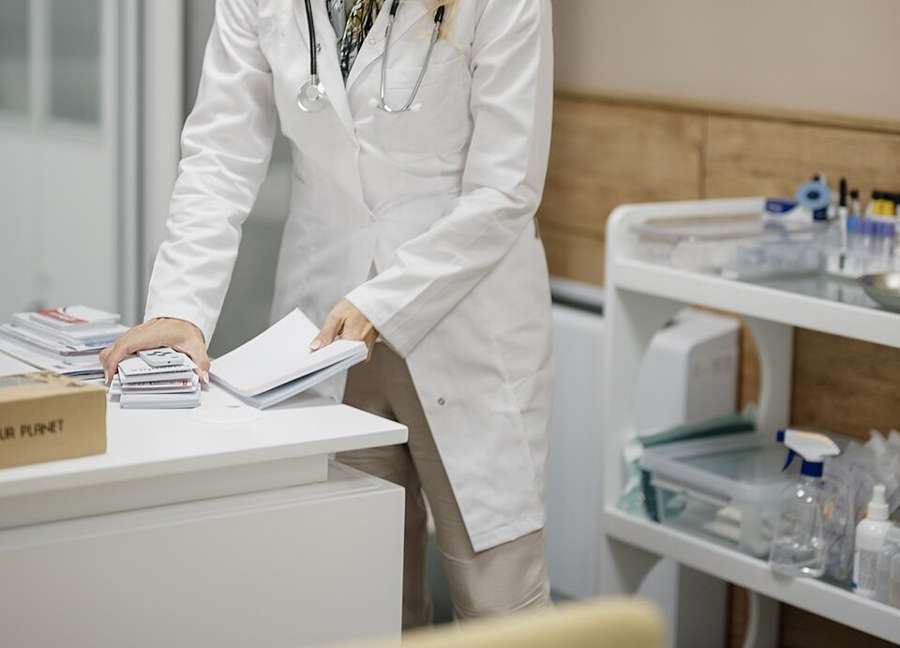 A doctor preparing for a consultation in a private medical office