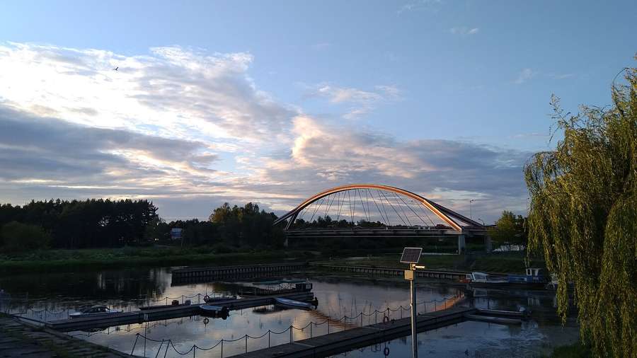 A footbridge arch over the Narew river marina in Ostrołęka