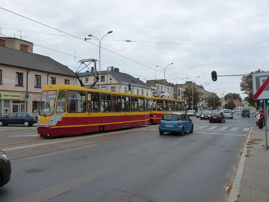 Yellow and red Łódź tram on a street in Pabianice