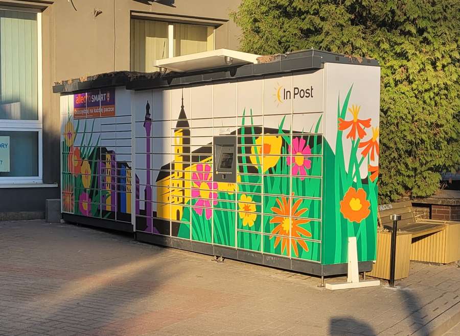 A decorated InPost Paczkomat parcel locker with a floral mural on Kopernika Street in Warsaw