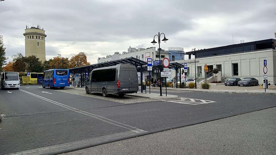 Bus station in Piotrków Trybunalski with buses and a water tower